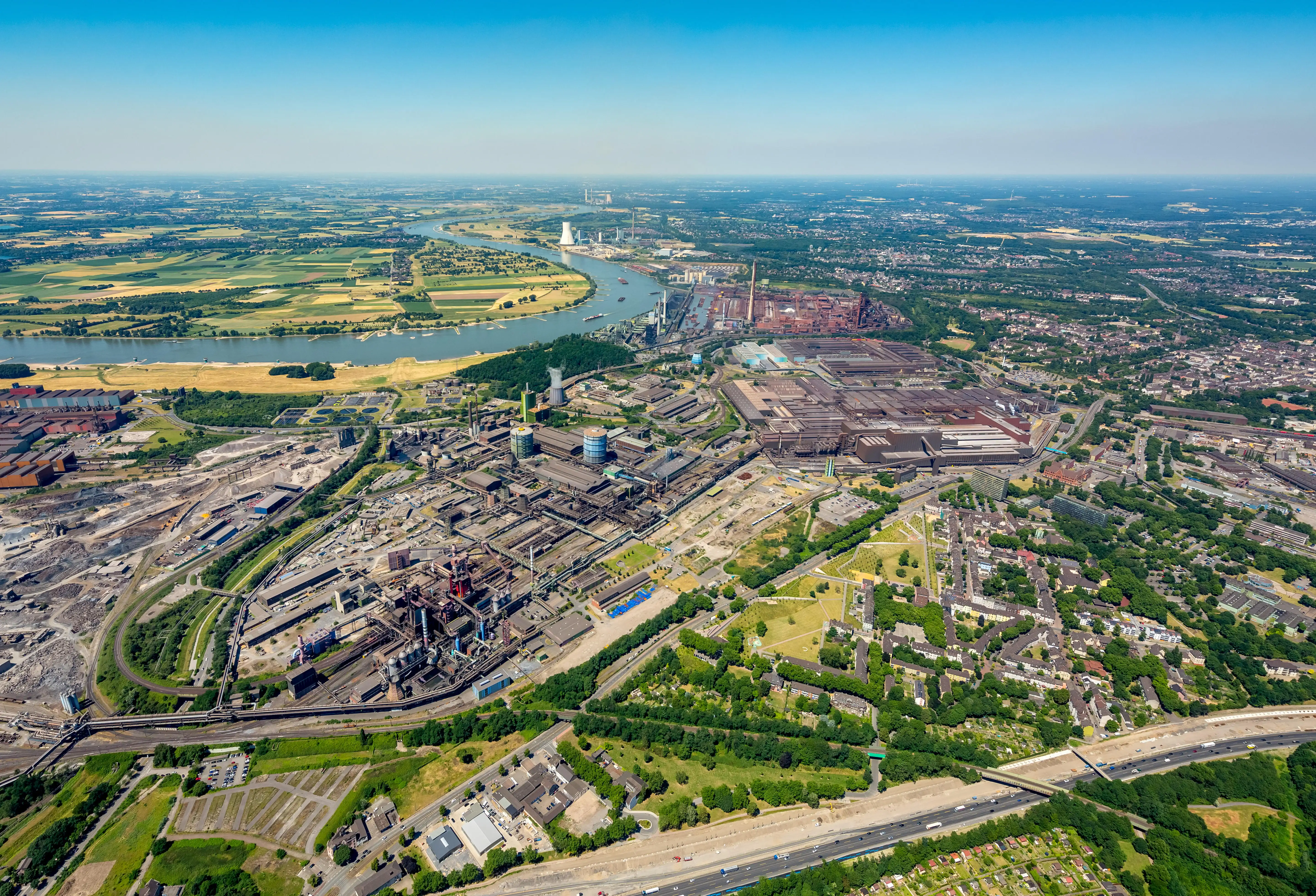 An industrial park next to a town and river